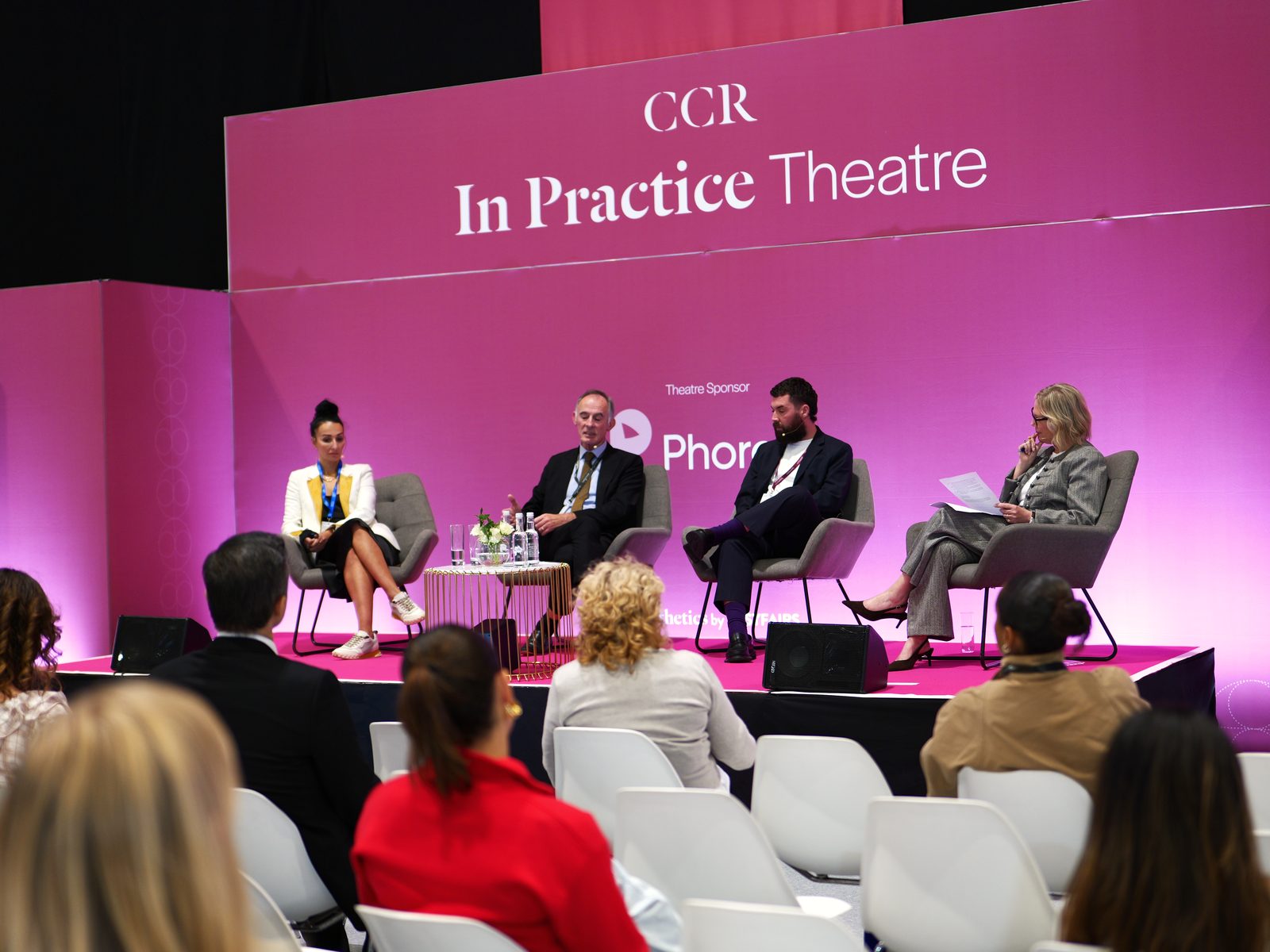 A panel session in progress at CCR with a seated audience, photographed by Kyros