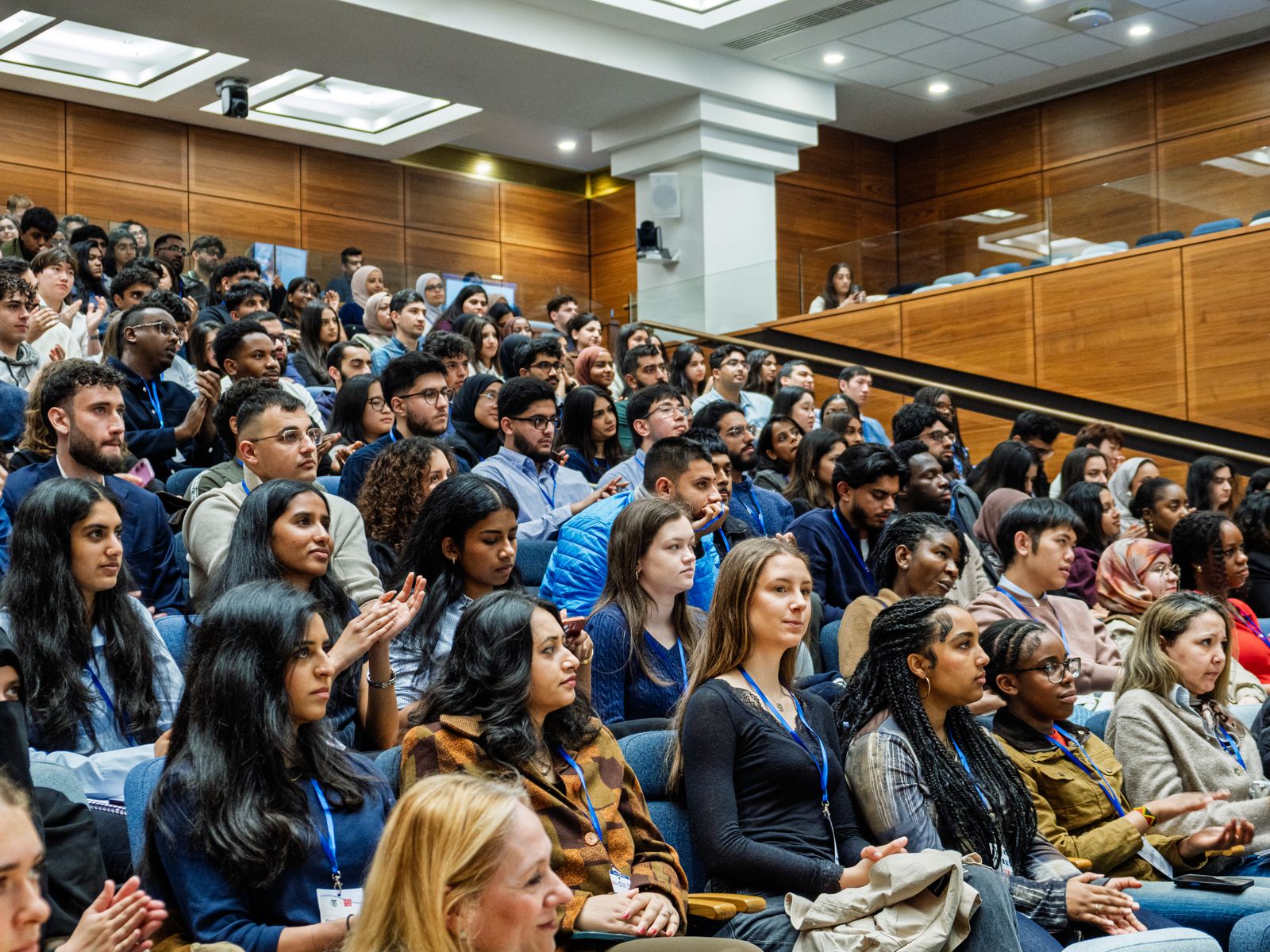 Delegates in a packed conference hall, photographed by Kyros